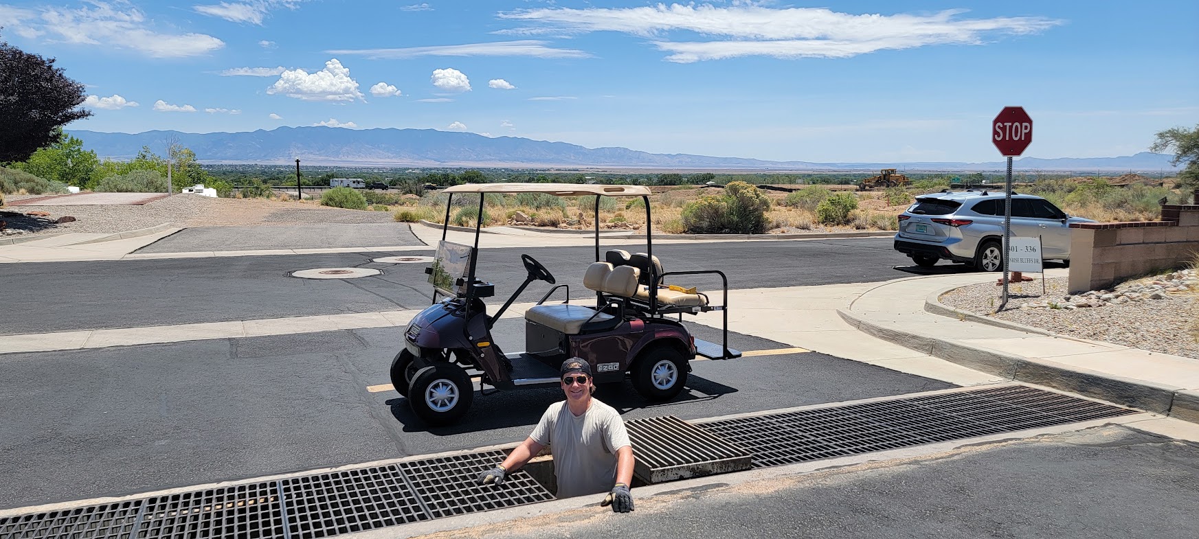 Ashton Keith emerging from storm grate with golf cart