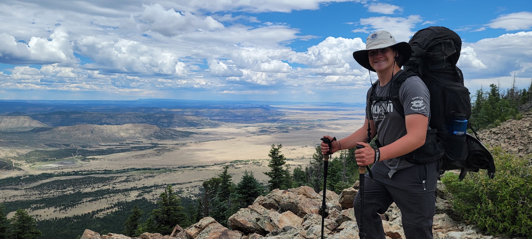 Ashton Keith backpacking at mountain summit